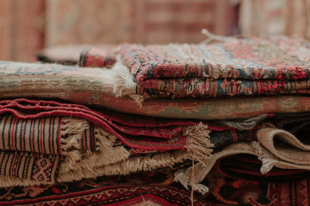 a pile of rugs stacked on top of each other